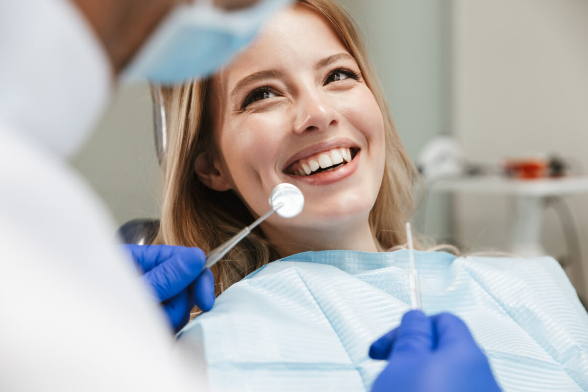 Patient smiling in the dental chair during an aligner consultation